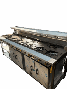 Commercial multi-burner gas cooker, front view — staggered cast burners with cupboard doors below
